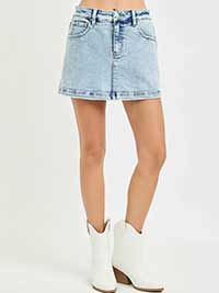 Denim skirt worn by a person on a white background