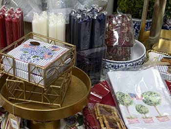 Table with decorative items including candles, gift bags, and a box of tissues.