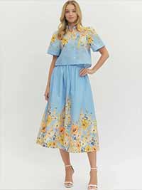 Woman wearing a light blue floral set on a white background