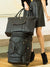 black quilted vip travel tote on top of matching luggage bag