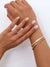 cz stone knot bracelet layered on model's wrist