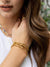 gold bamboo bangle bracelets layered on model