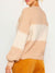 back of cream and beige colorblock sweater on model