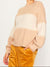 cream and beige colorblock sweater closeup on model