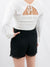 white long sleeve crop top with smocked back on model from back
