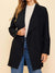 black collared cardigan on model holding side