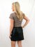 black faux leather skirt on model from back