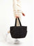 model holing quilted nylon tote