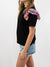 black tee with iridescent ruffle sleeves from side