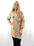 beige long sweater with blue stars on model from front