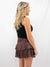 smocked chocolate brown ruffle mini skirt on model from back