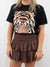 chocolate smocked mini skirt paired with graphic tee on model