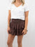 white pocket tee paired with chocolate smocked skort