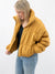 camel puffer jacket on model from side