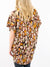 olive, brown, and orange animal print top from back