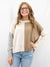 neutral colorblock sweater on model from front