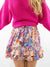 close up of fuchsia boat neck sweater material with skirt