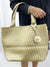 gold and platinum reversible woven tote bag on model