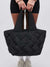 black quilted woven tote held by model