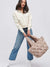model holding quilted nude tote