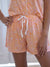 orange and pink jungle themed shorts on model