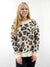 fuzzy leopard sweater on model from front