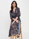 Winter Odyssey Maxi Dress by Meet Me in Santorini in navy floral pattern on model from front sitting on a stool with arms crossed
