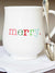 coffee mug with merry written in colorful writing