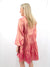 metallic pink button up shirt dress on model from back