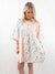 light blue and pink floral shirt dress on model