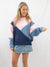 navy blue and pink color block sweater on model from front
