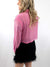 rhinestone pink button up crop top on model from back with skirt