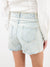 denim shorts with pink jewels on model from back