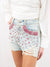 denim shorts with pink jewels on model from side