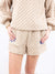 ivory quilted shorts on model from front