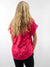 pink and red zebra print top on model from back