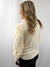 model is wearing cream knit shirt from back with puff sleaves