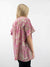 light pink mauve safari pattern blouse on model from back