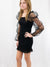 smocked black bodycon dress on model from side