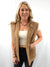 tan faux leather and sherpa vest on model