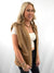side of tan faux leather and sherpa vest on model