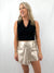 faux leather champagne skort on model from front