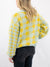 houndstooth yellow and mint cardigan on model from back