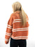 rust white striped sweater on model from back