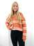 rust white striped sweater on model