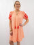 front of embroidered sleeve orange dress on model