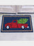 classic Christmas red truck on navy coir doormat