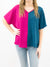 magenta and teal two tone v-neck top on model