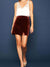 rust velvet mini skirt on model