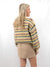 multicolor crew neck sweater on model from back with skirt